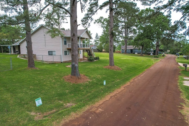 exterior space with stairway, fence, a yard, and a deck