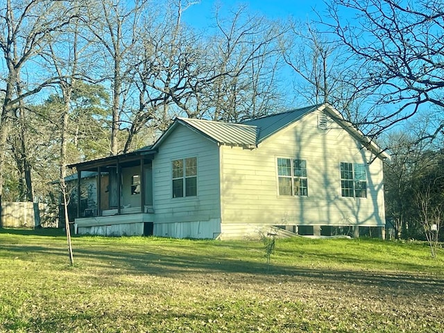 view of property exterior featuring a yard and covered porch