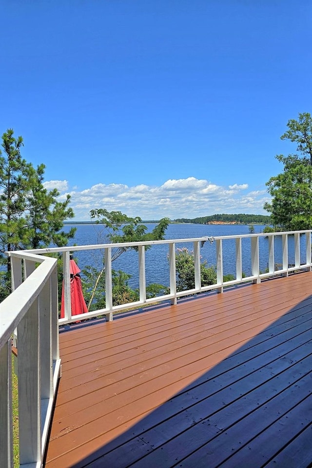 wooden terrace featuring a water view