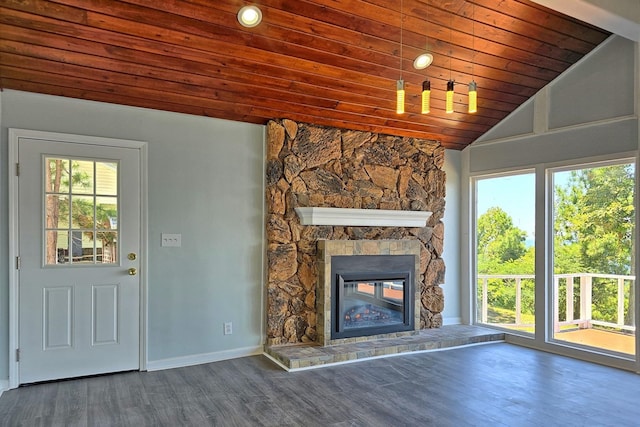 unfurnished living room featuring a stone fireplace, a wealth of natural light, dark wood-type flooring, and wood ceiling