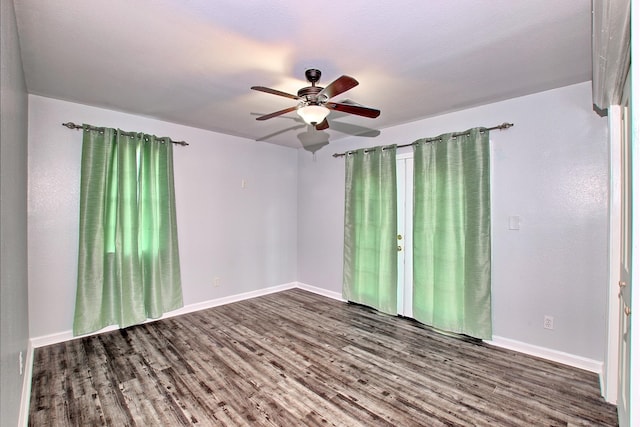 unfurnished room featuring ceiling fan and dark wood-type flooring