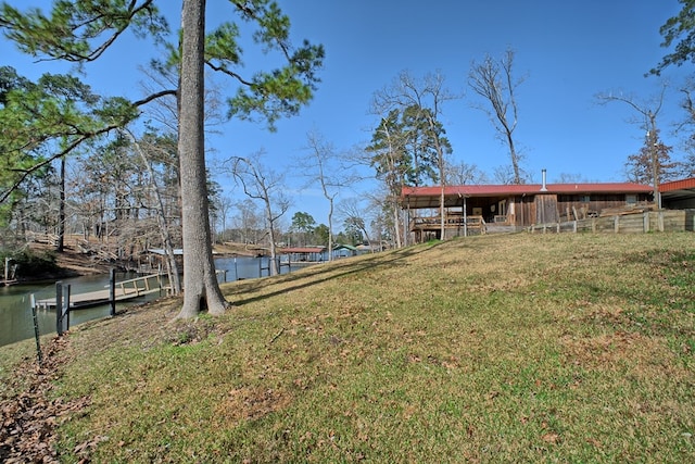 view of yard with fence and a water view