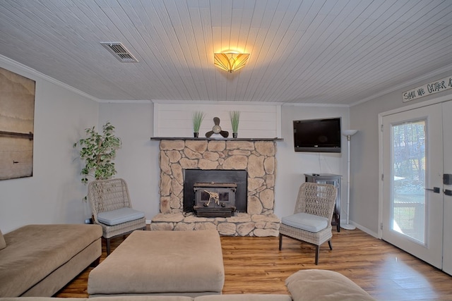 living room featuring visible vents, ornamental molding, wood finished floors, baseboards, and wood ceiling