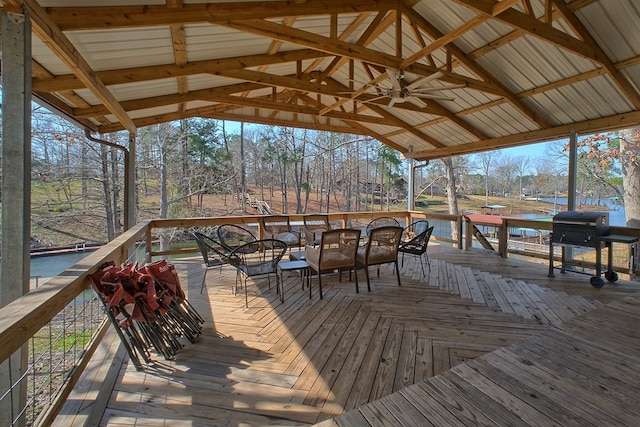 wooden terrace featuring ceiling fan and a grill