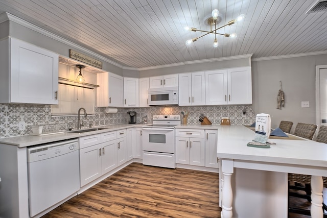 kitchen with ornamental molding, a sink, backsplash, white appliances, and a peninsula