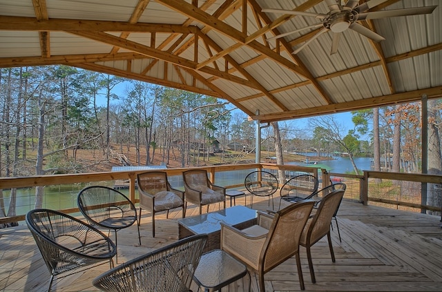 deck featuring ceiling fan and a water view