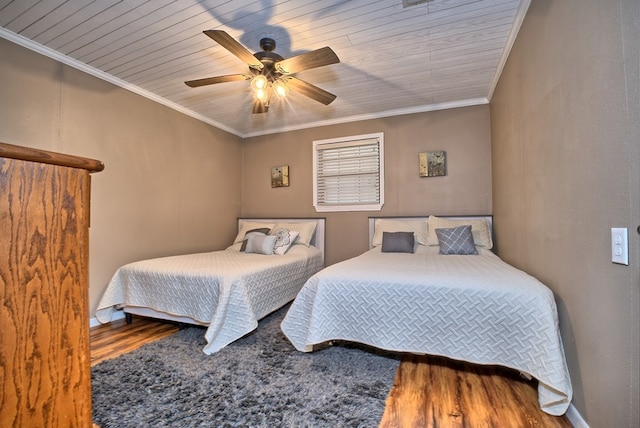 bedroom featuring wooden ceiling, wood finished floors, ceiling fan, and ornamental molding