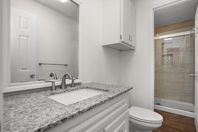 413 Linn St, Huntington, TX 75949 - full bathroom with vanity, a shower stall, toilet, and wood finished floors