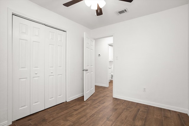 413 Linn St, Huntington, TX 75949 - unfurnished bedroom featuring dark wood-style floors, a closet, baseboards, and a ceiling fan