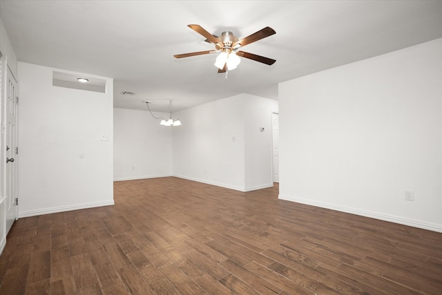 413 Linn St, Huntington, TX 75949 - empty room with a ceiling fan, dark wood finished floors, a chandelier, and baseboards