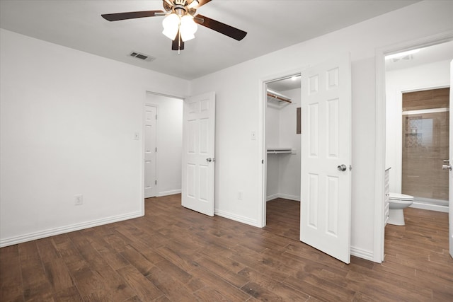 413 Linn St, Huntington, TX 75949 - unfurnished bedroom with dark wood-style floors, a spacious closet, baseboards, a closet, and ensuite bath