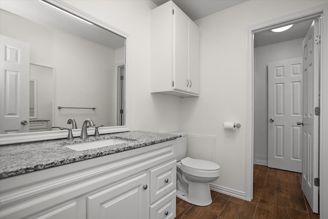 413 Linn St, Huntington, TX 75949 - bathroom with vanity, wood finished floors, toilet, and baseboards