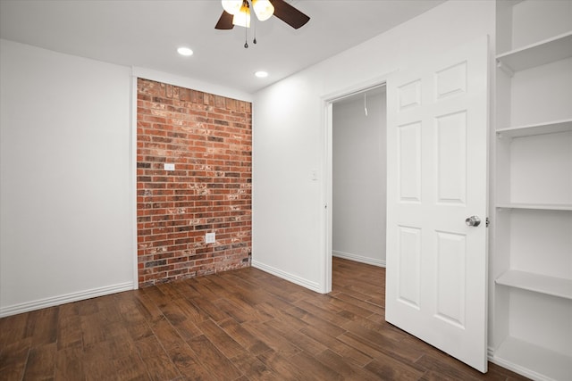 413 Linn St, Huntington, TX 75949 - unfurnished bedroom featuring brick wall, dark wood finished floors, recessed lighting, baseboards, and a ceiling fan