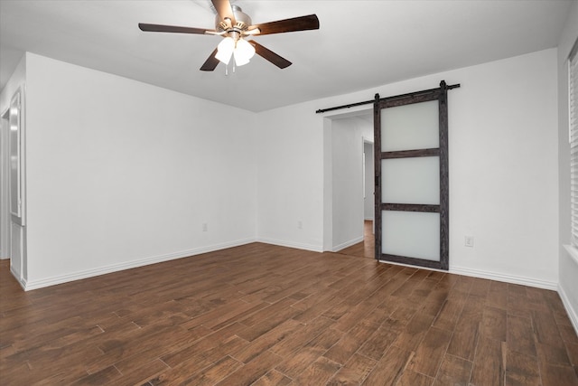 413 Linn St, Huntington, TX 75949 - spare room with a barn door, a ceiling fan, dark wood-style flooring, and baseboards