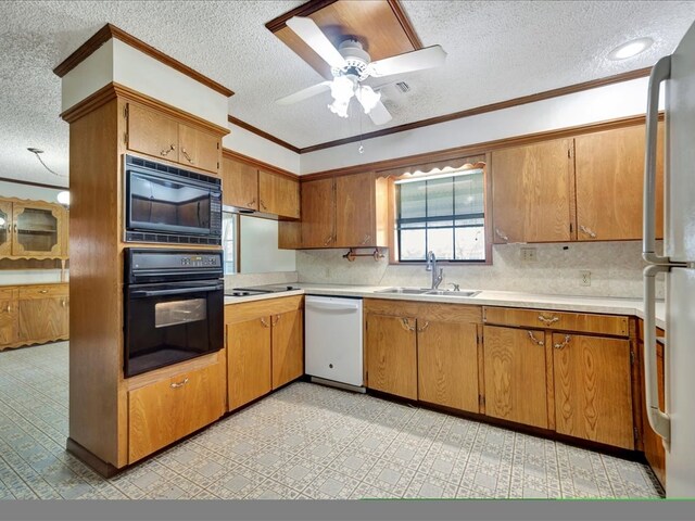 kitchen featuring a textured ceiling, ceiling fan, crown molding, sink, and black appliances