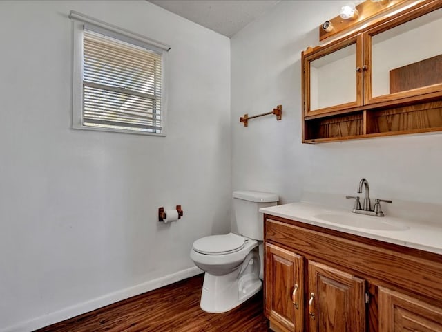 bathroom featuring vanity, toilet, and wood-type flooring