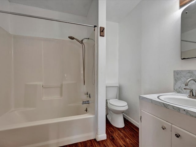 full bathroom with bathtub / shower combination, vanity, hardwood / wood-style flooring, and toilet