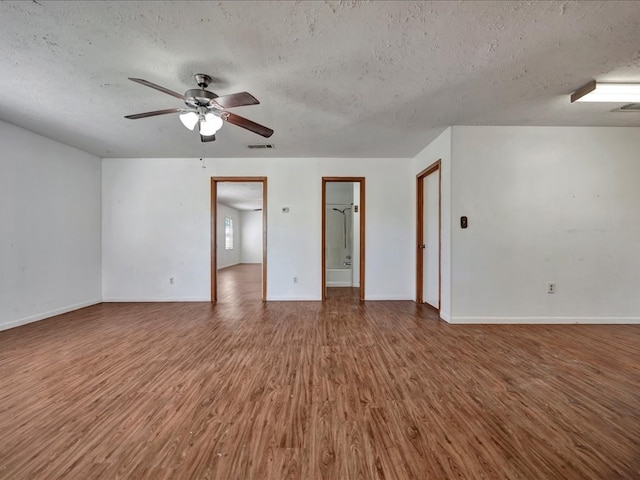 unfurnished room featuring hardwood / wood-style floors, ceiling fan, and a textured ceiling