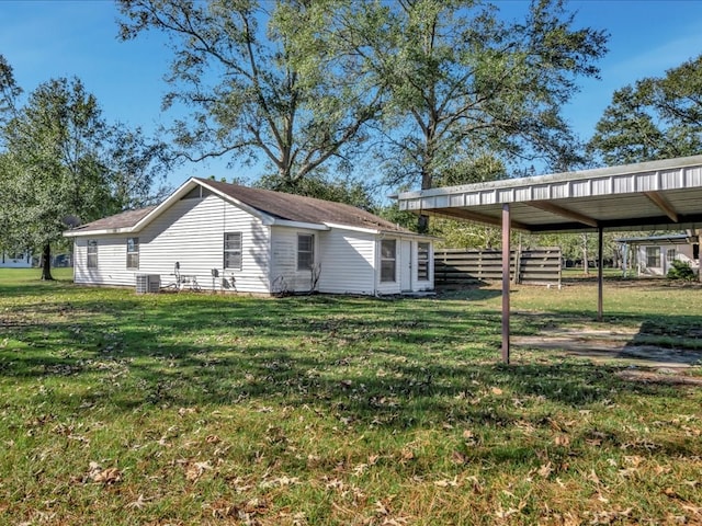 exterior space with a carport and a yard