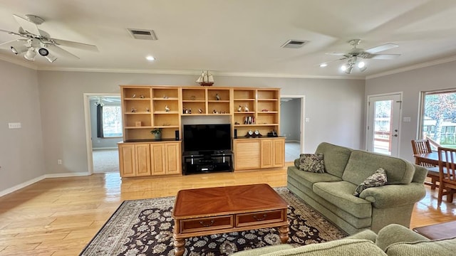 living room featuring crown molding, ceiling fan, and light hardwood / wood-style floors