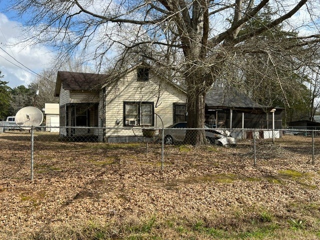 104 Pearl St, Timpson, TX 75975 - view of front of home featuring a sunroom and fence