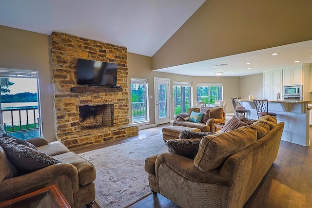 232 Cove Ln, Brookeland, TX 75931 - living room with dark wood-style floors, a large fireplace, high vaulted ceiling, and recessed lighting
