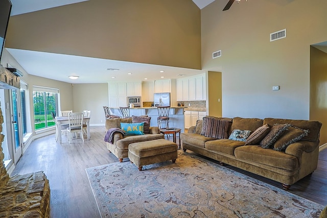 232 Cove Ln, Brookeland, TX 75931 - living room with light wood-type flooring, baseboards, high vaulted ceiling, and a ceiling fan