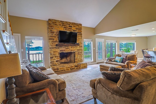 232 Cove Ln, Brookeland, TX 75931 - living room with a stone fireplace, wood finished floors, and vaulted ceiling
