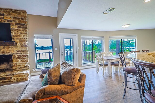 232 Cove Ln, Brookeland, TX 75931 - dining space with wood finished floors and a fireplace