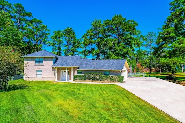 232 Cove Ln, Brookeland, TX 75931 - view of front facade with concrete driveway, an attached garage, and brick siding