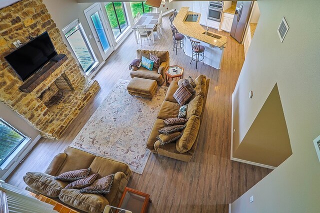 232 Cove Ln, Brookeland, TX 75931 - living area with wood finished floors and a fireplace with raised hearth