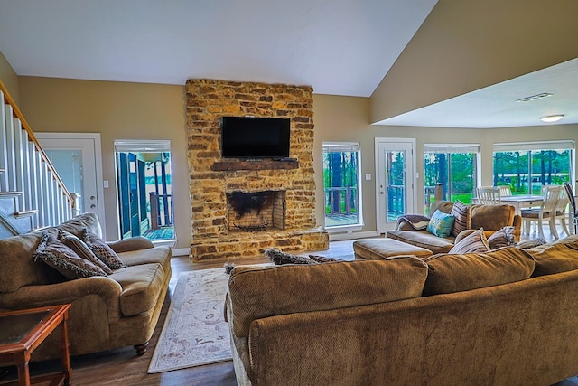 232 Cove Ln, Brookeland, TX 75931 - living area with wood finished floors, stairs, a fireplace, and lofted ceiling