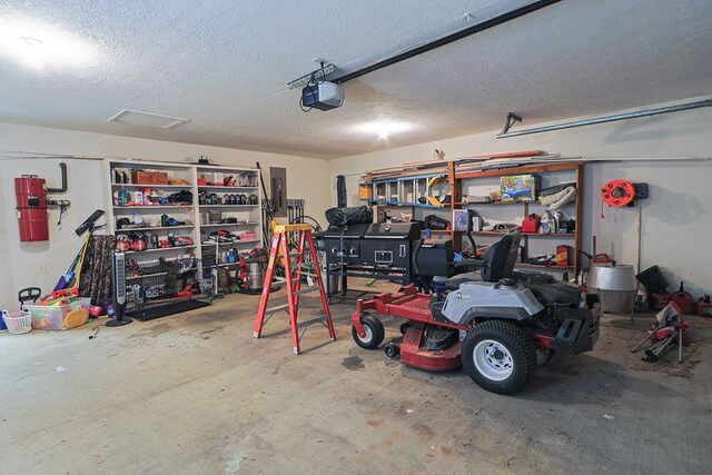 232 Cove Ln, Brookeland, TX 75931 - garage with a garage door opener, a central vacuum unit, and electric panel