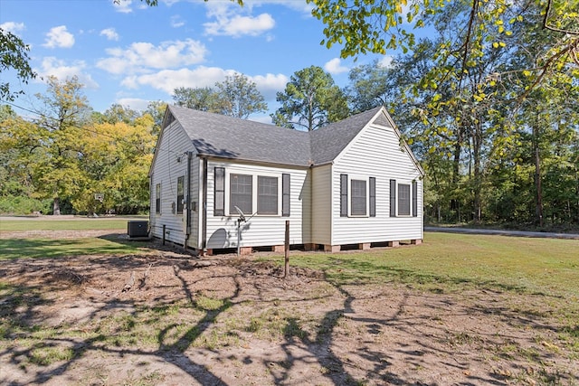 view of property exterior with a yard and central AC unit