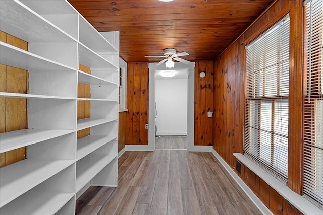 doorway to outside with ceiling fan, hardwood / wood-style flooring, wood ceiling, and wood walls