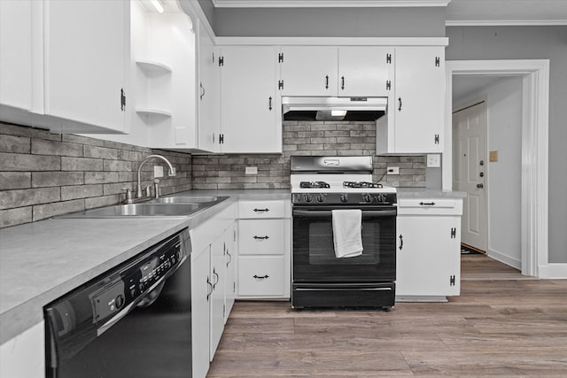 kitchen featuring black appliances, white cabinets, sink, and light hardwood / wood-style flooring