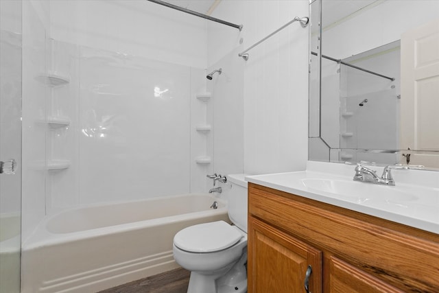 full bathroom featuring toilet, wood-type flooring, vanity, and tiled shower / bath combo