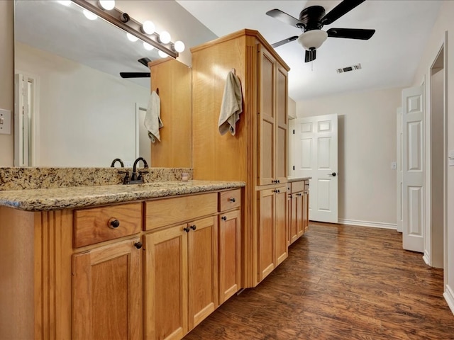 bathroom with ceiling fan, vanity, and wood-type flooring