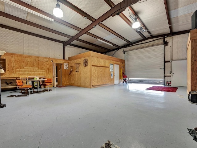 garage featuring wood walls and a carport