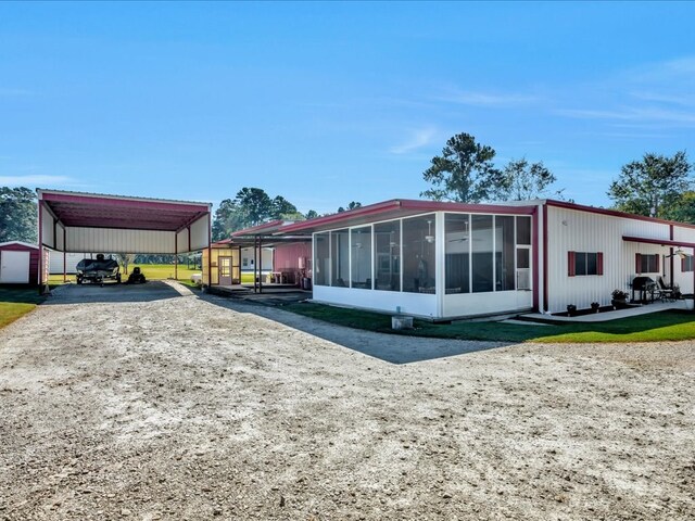 exterior space featuring a carport and a sunroom