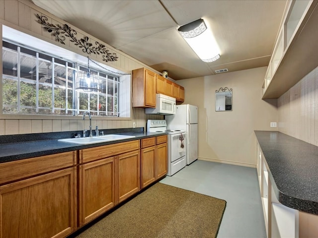 kitchen featuring white appliances, sink, and tasteful backsplash