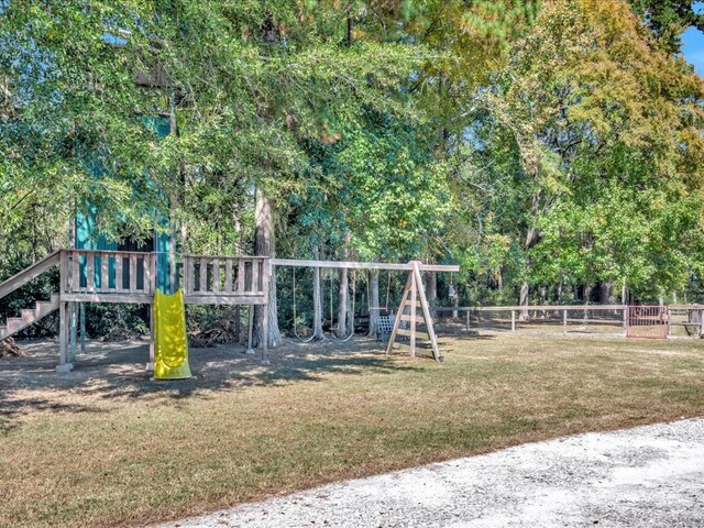 view of jungle gym featuring a lawn