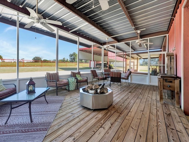 sunroom / solarium featuring ceiling fan