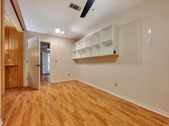 spare room with light hardwood / wood-style flooring and ceiling fan