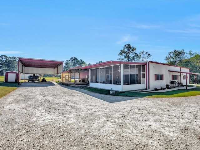 exterior space with a sunroom and a carport