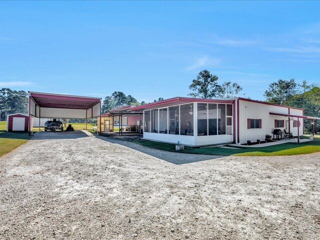 exterior space with a sunroom and a carport