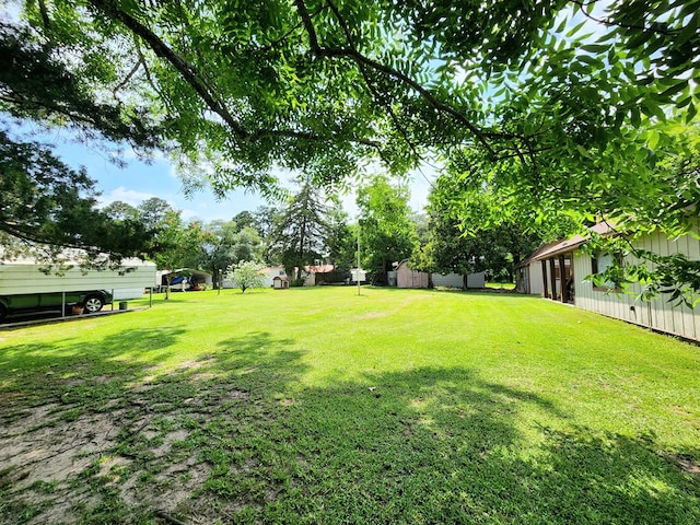 493 Hideaway Loop, Hemphill, TX 75948 - view of green lawn with a carport