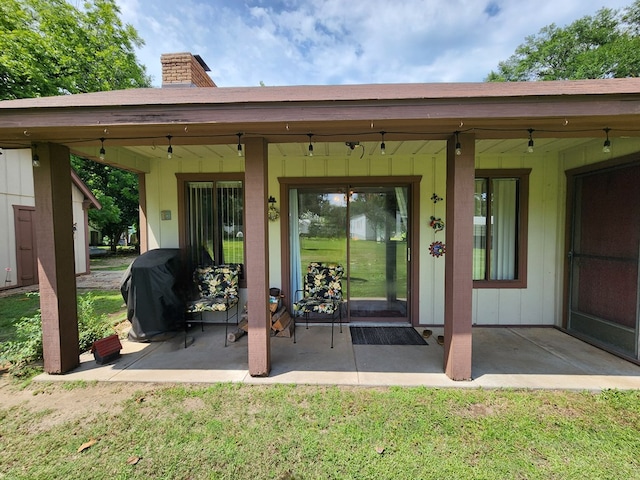 493 Hideaway Loop, Hemphill, TX 75948 - property entrance with a patio area, a chimney, and a lawn