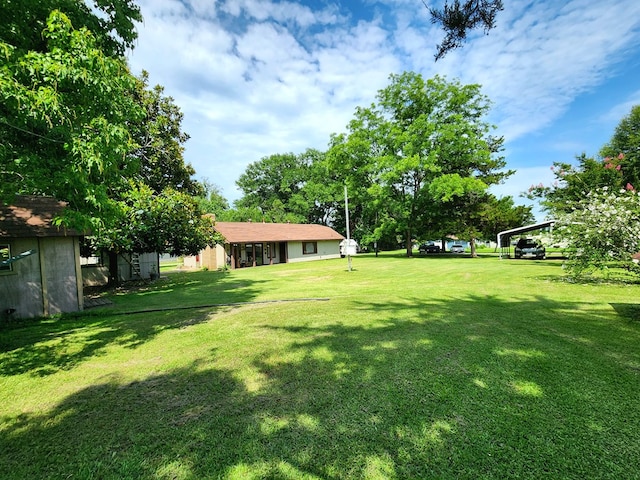 493 Hideaway Loop, Hemphill, TX 75948 - view of grassy yard with a carport