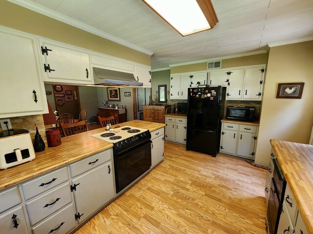 493 Hideaway Loop, Hemphill, TX 75948 - kitchen with black appliances, butcher block counters, range hood, ornamental molding, and light wood-style flooring